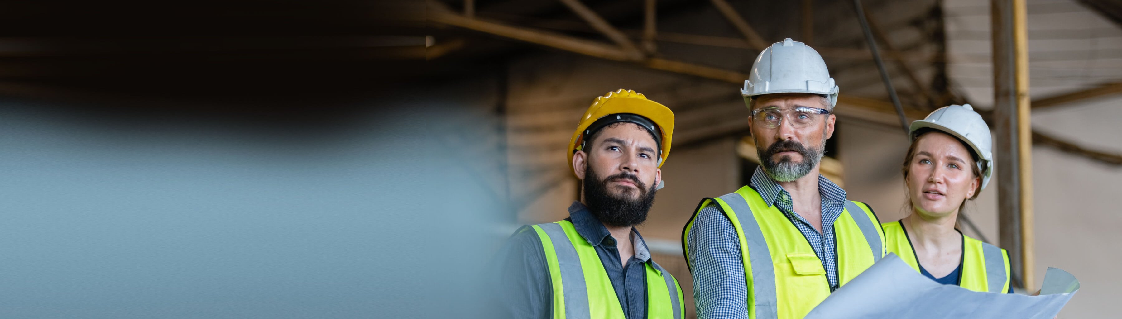 Industrial engineers team standing holding blueprints analyse project manufacturing metalwork in factory.