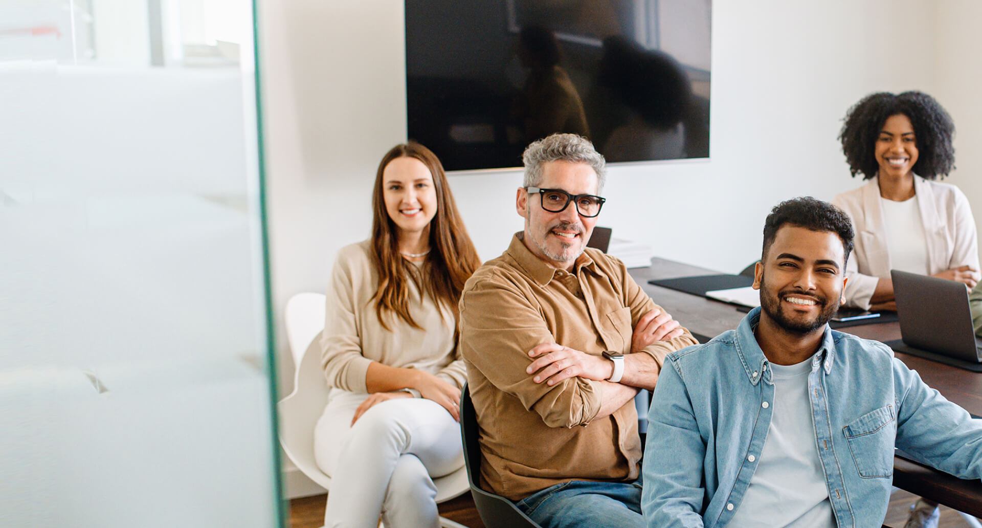 Smiling people inside at a psychosocial risk management presentation