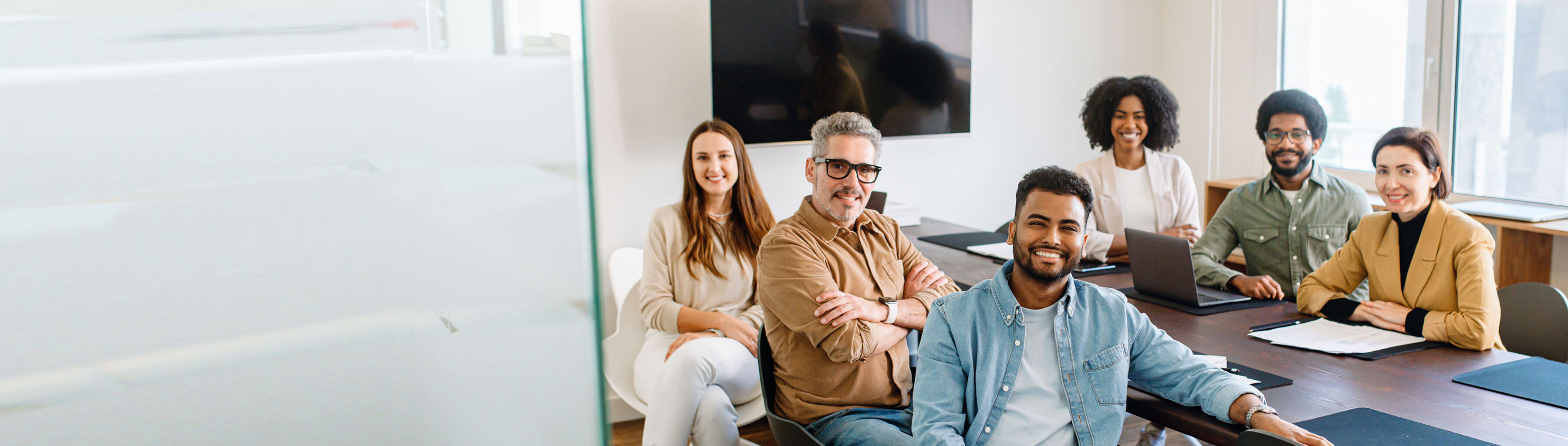 Smiling people inside at a psychosocial risk management presentation