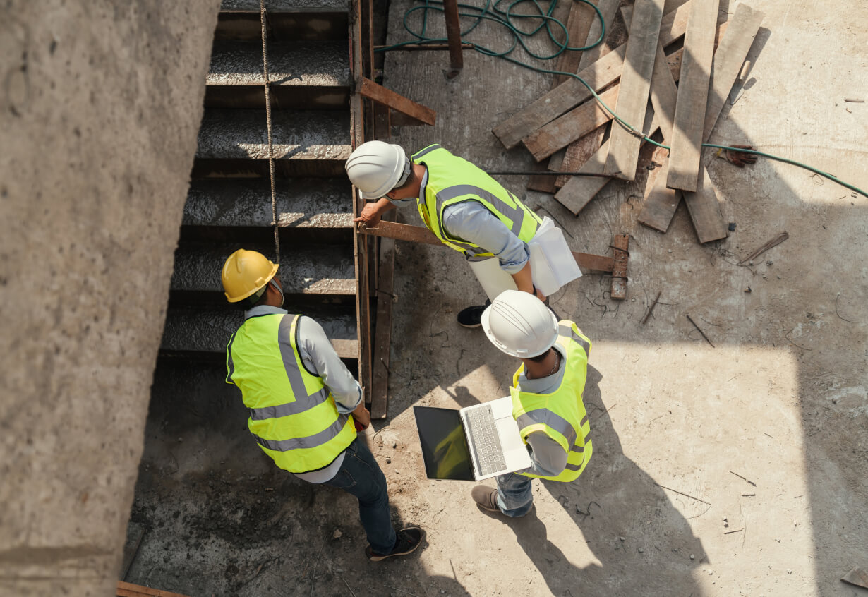 Top view, Team civil engineer inspection concrete pouring make stair at construction site. Building project with Civil Engineer, Contractor and Architect in construction site.