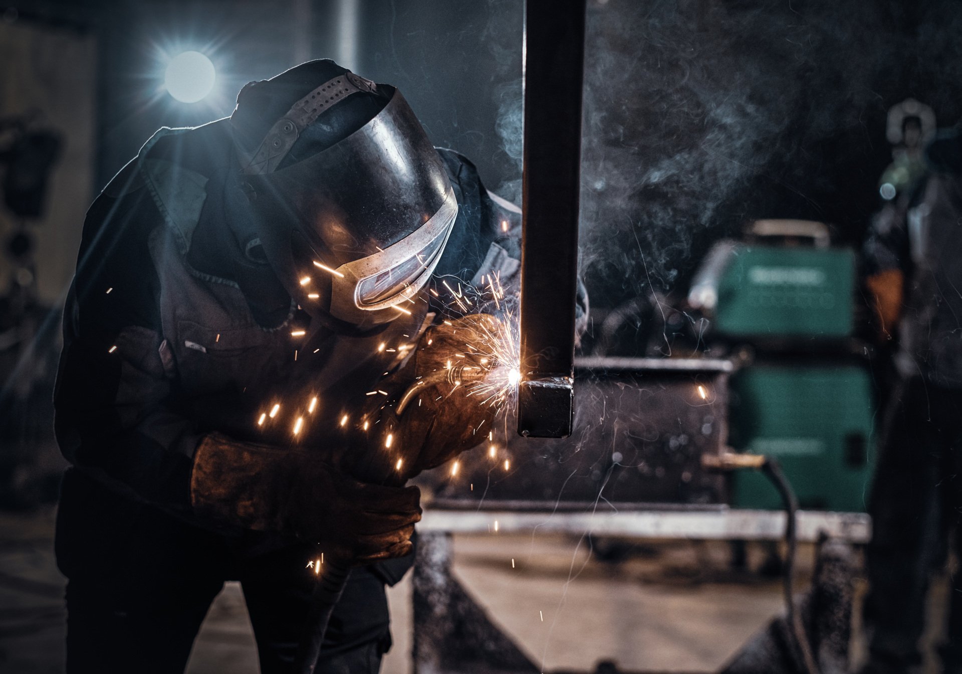 Man is working at the busy metal factory
